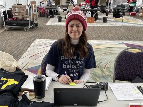 A volunteer checking people in for an event