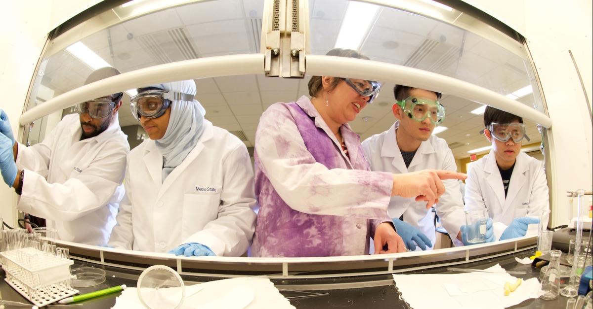 chemistry students being led by faculty in lab