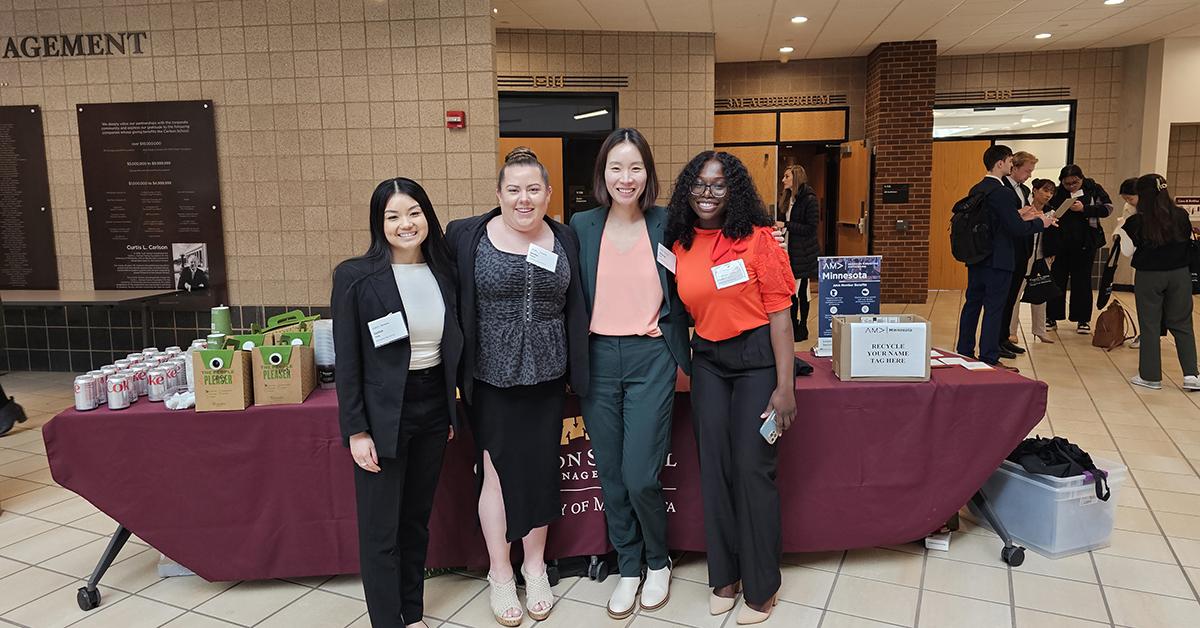 A group of people pose for a picture in front of a table