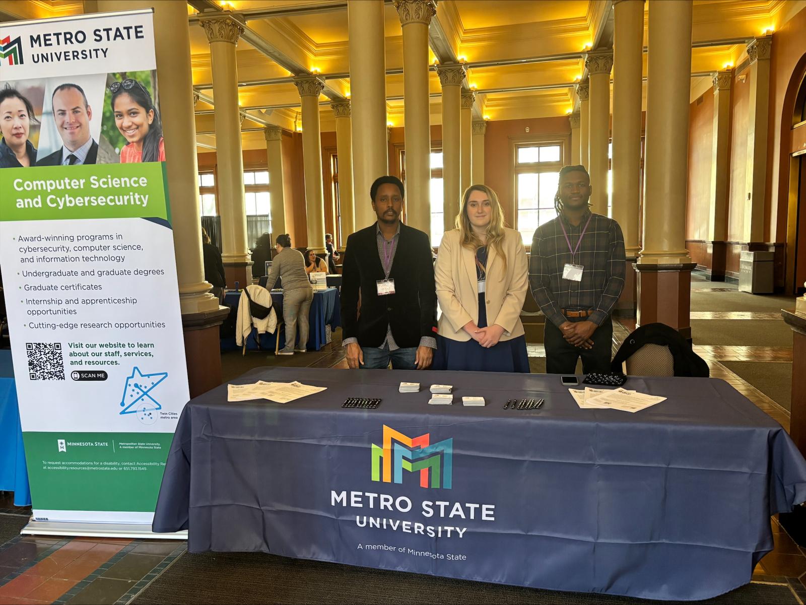 Metro State Cyber Clinic representatives at the Metro State booth