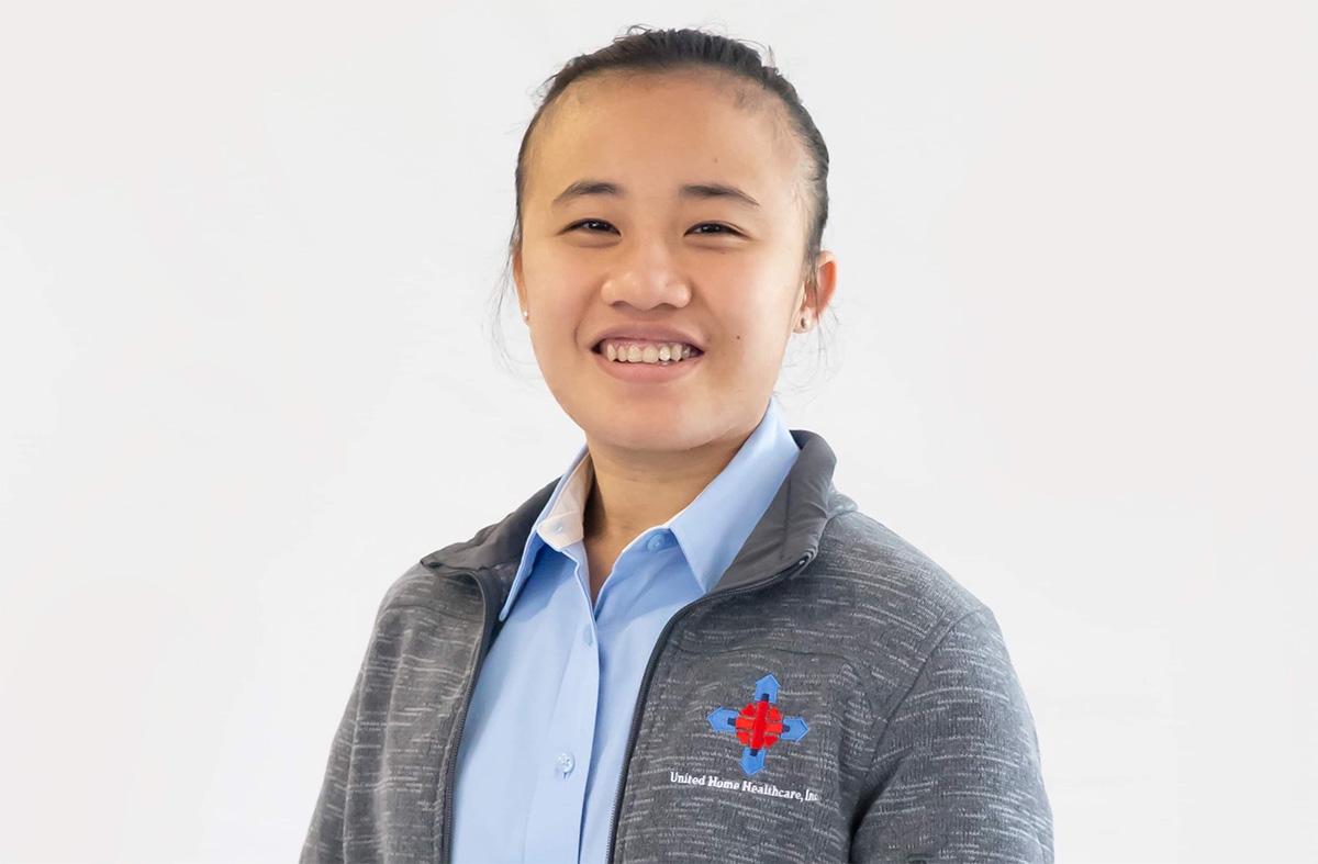 Graduate smiling in front of white background