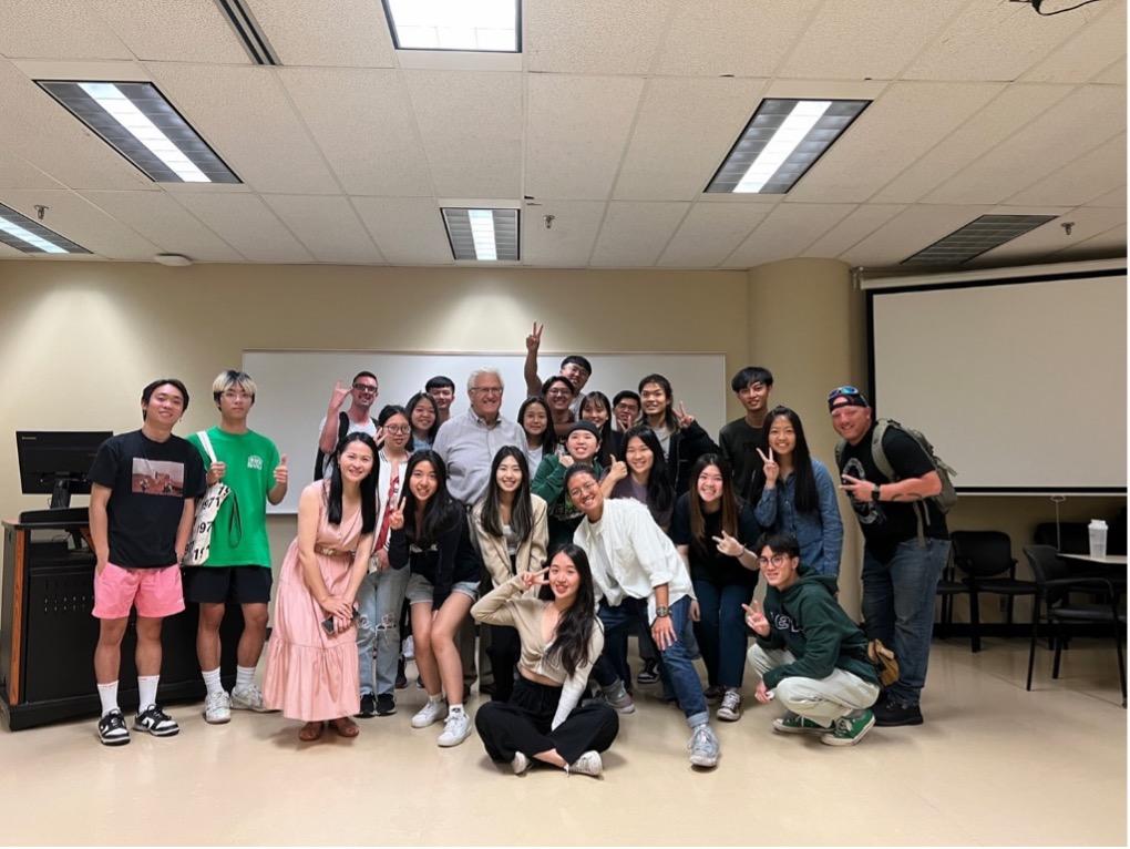 a group of students pose in a classroom