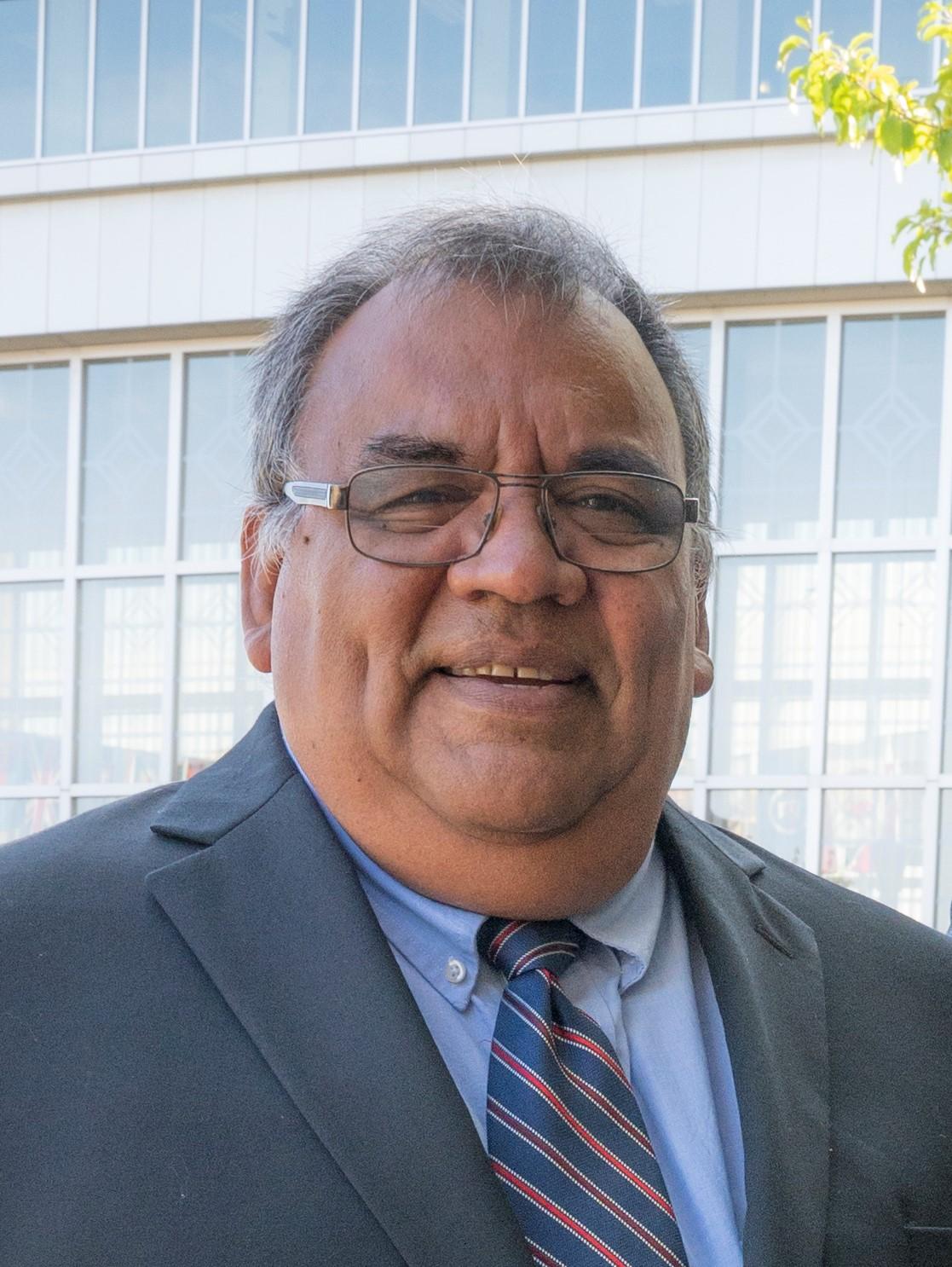 A man in a gray jacket and light shirt