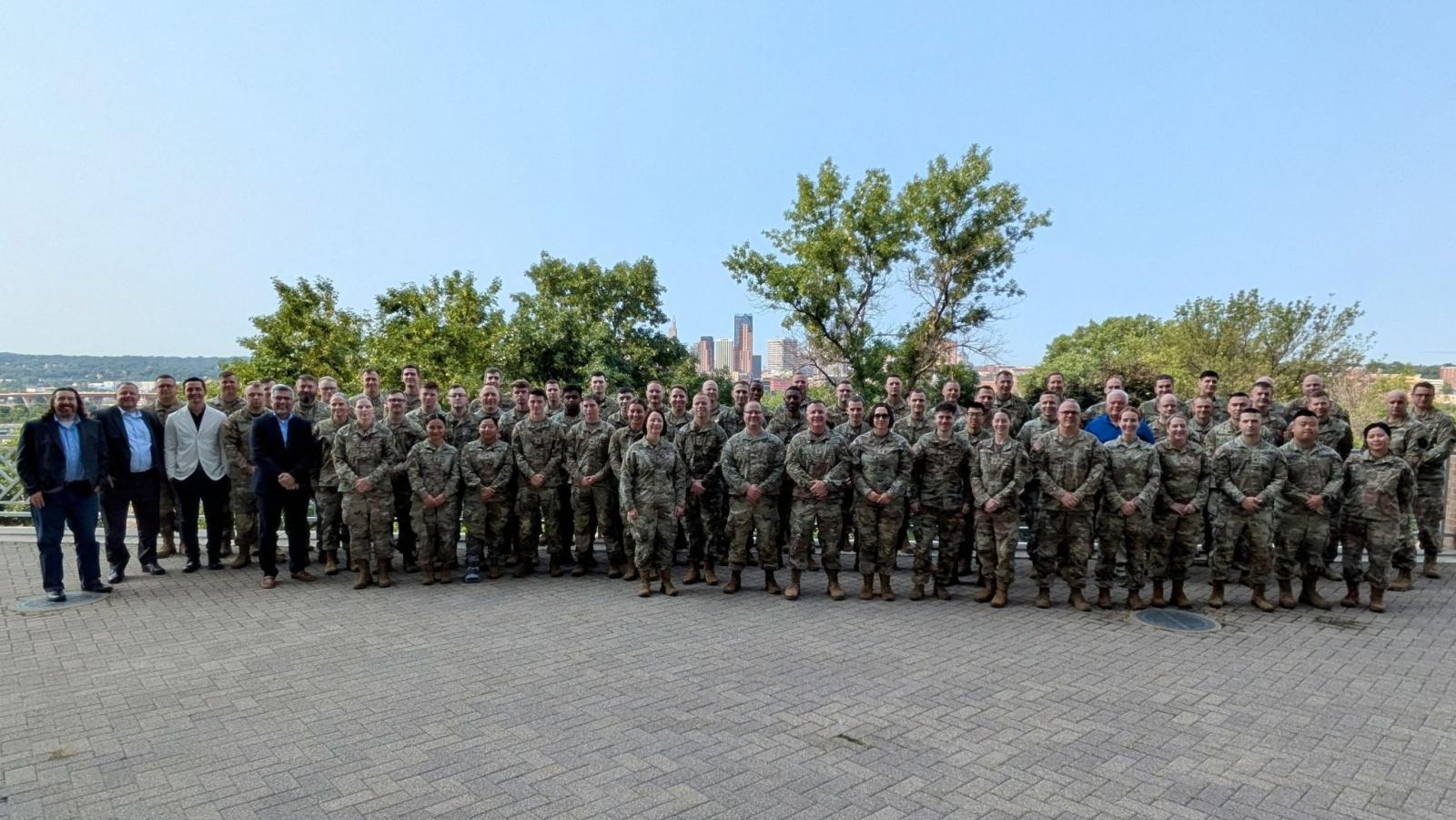 Attendees of the Minnesota Military Cyber Symposium pose for a group picture on the patio outside New Main