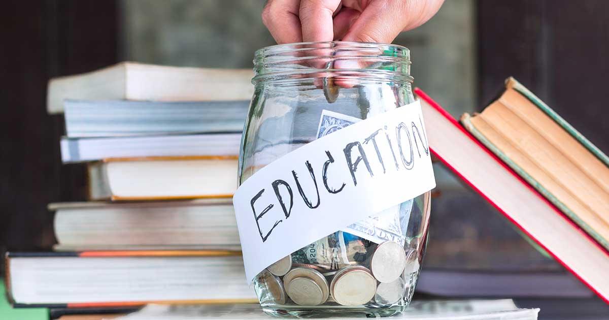 A jar with coins and bills in it, labeled 'education.'